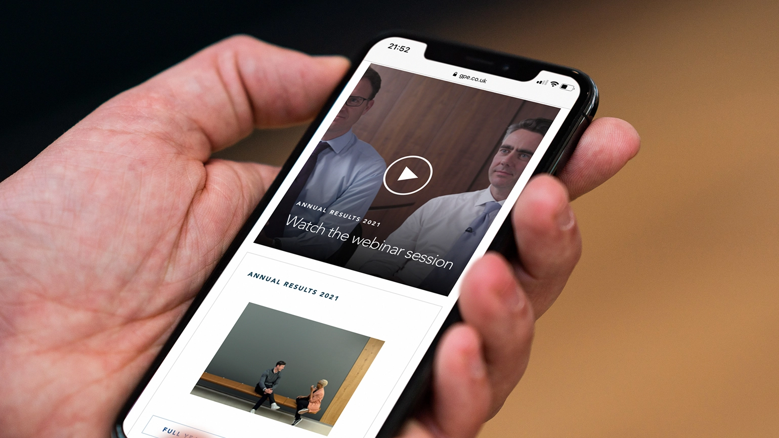 A hand browsing a website on a phone