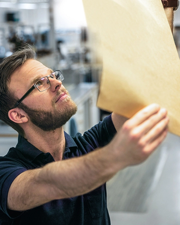 A man is looking at a piece of paper