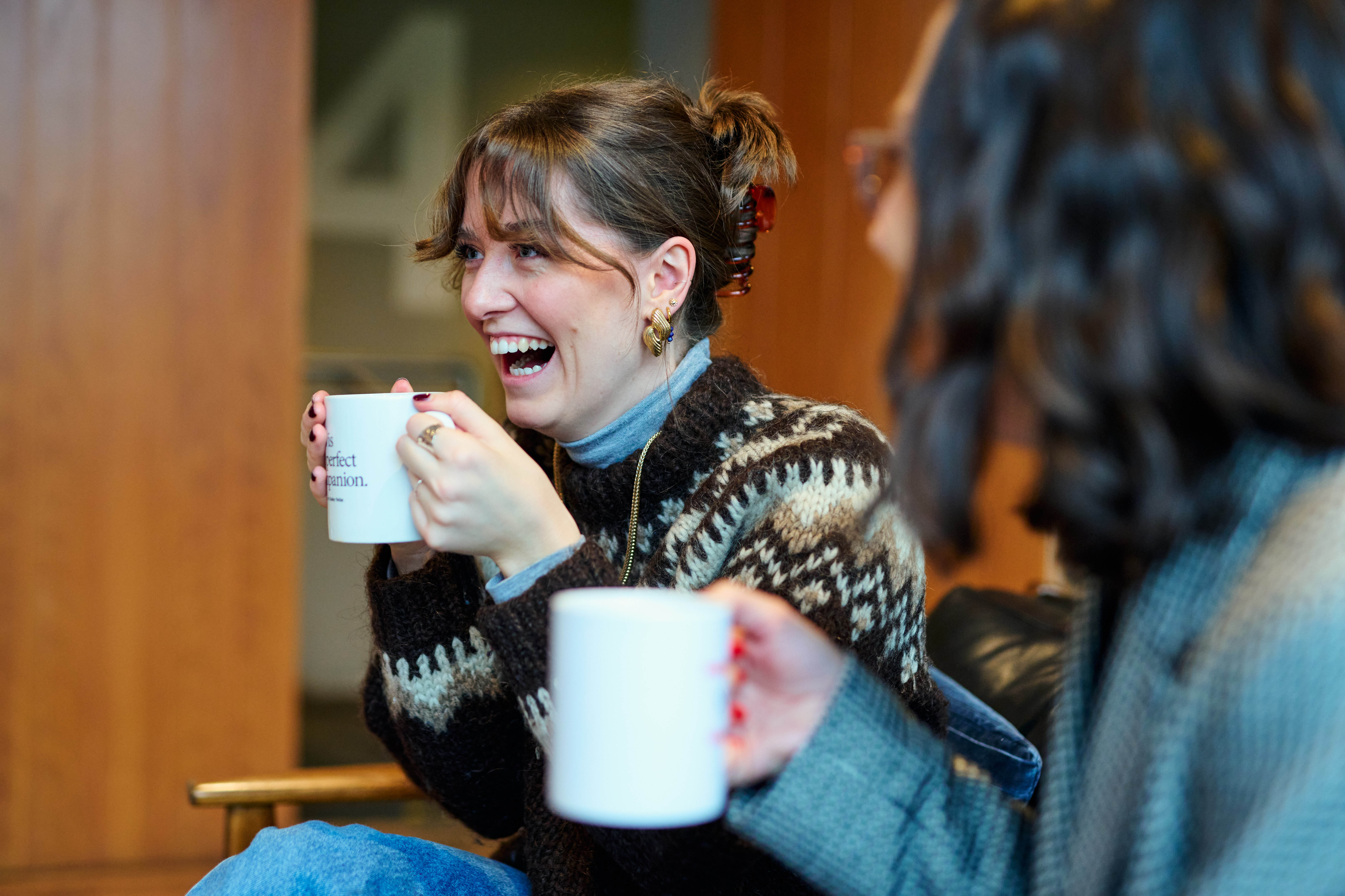 Radley Yeldar employee drinking a coffee and laughing with team members