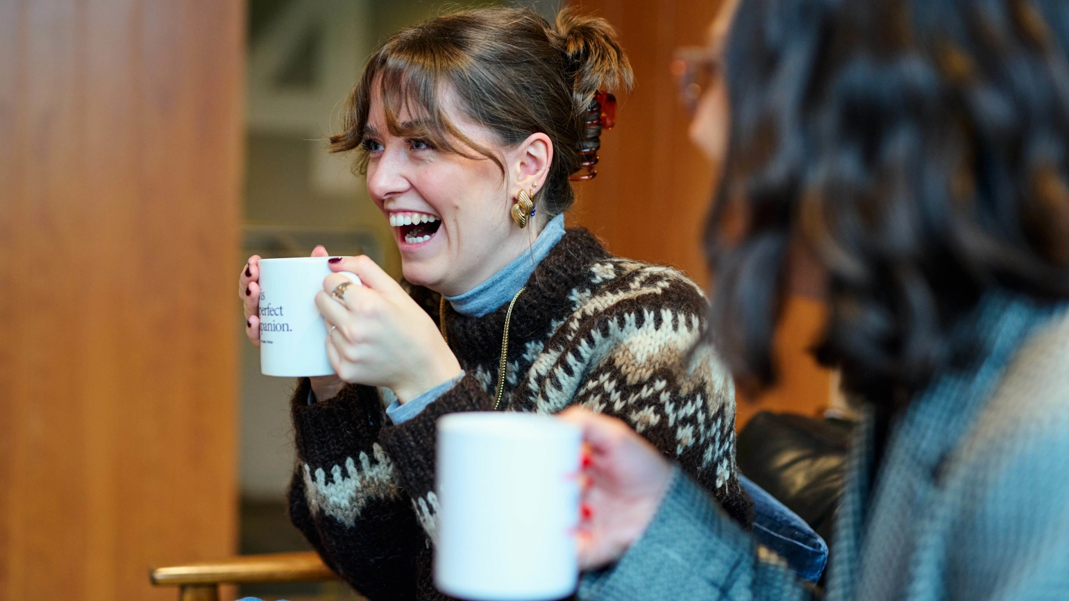 Radley Yeldar employee drinking a coffee and laughing with team members