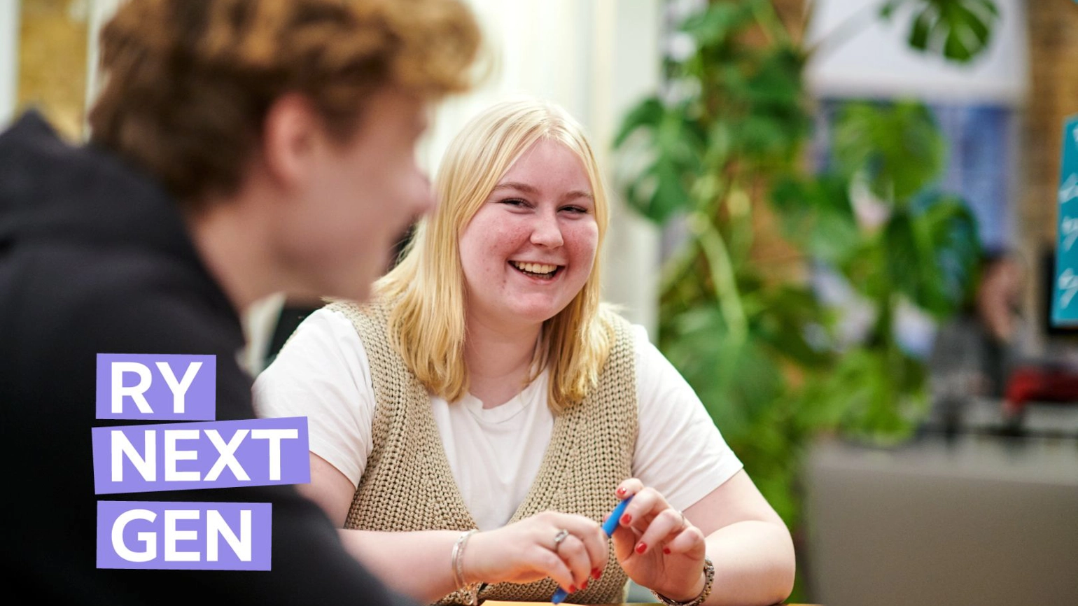 Image of Charlotte Radley, smiling as she sits at a desk